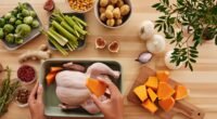 Hands preparing chicken with fresh vegetables on a wooden table.
