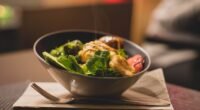 Delicious bowl of salad with fresh greens and grilled chicken served on a wooden platter.