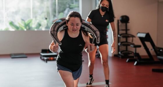 Two women focused on strength training in a Singapore gym with a personal trainer.