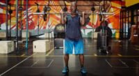 Muscular man lifting barbell in a colorful gym, exuding strength and fitness.