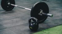 Barbell and kettlebell on gym floor, ideal for fitness and strength training themes.